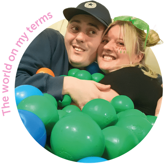 Support worker and care user in ball pit